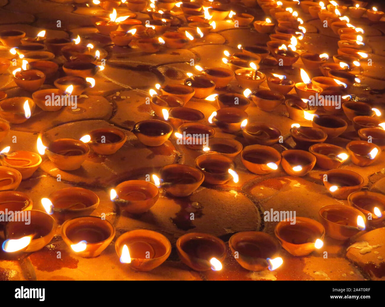 Traditional earthen lamps set on the floor for Diwali festival in India. Stock Photo