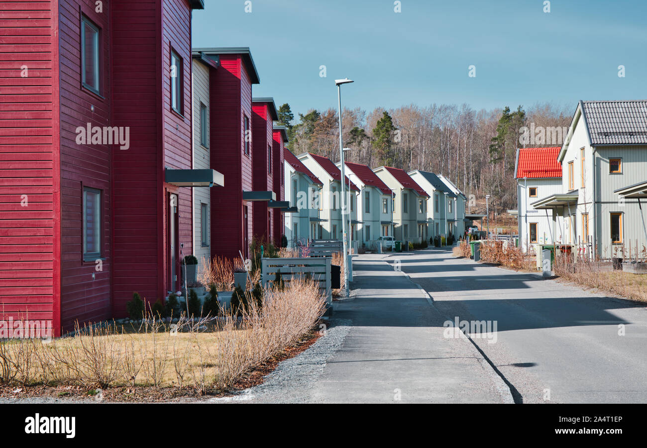 Street of newly built typical Swedish homes in the suburb of Runby, Upplands Vasby, Stockholm