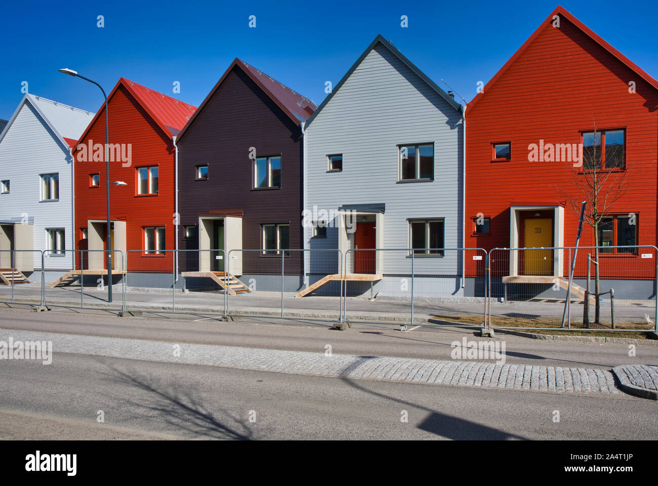 Colourful newly built typical Swedish homes in the suburb of Runby, Upplands Vasby, Stockholm County, Sweden Stock Photo