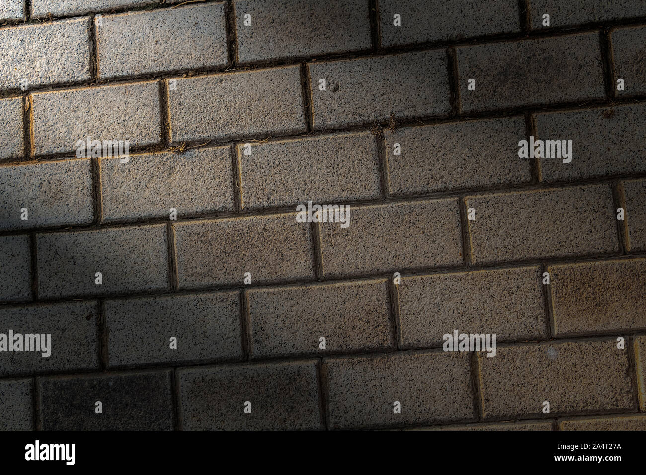 Lighted decorative beige brickwork as a closeup background. Stock Photo