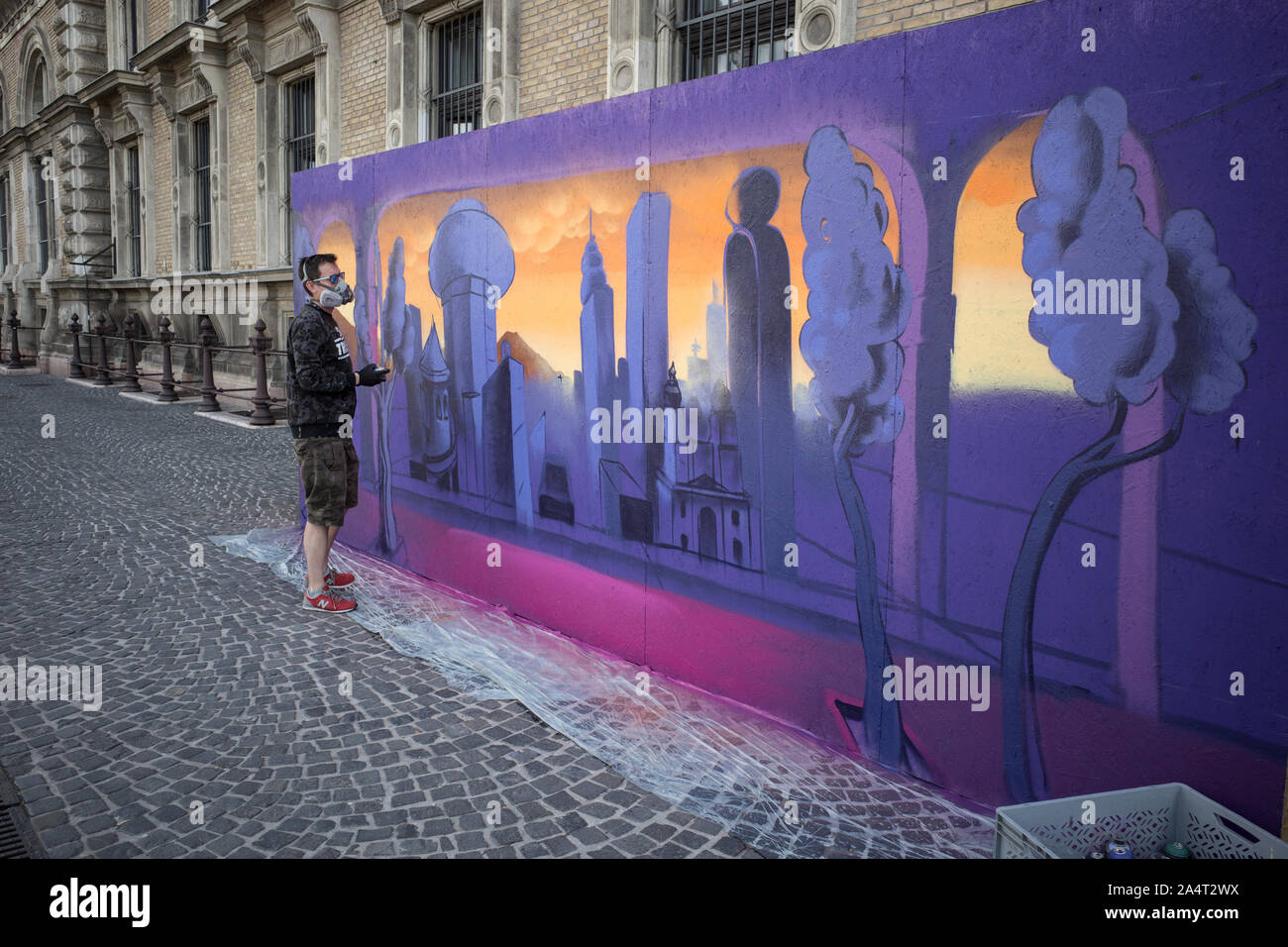 STREET ART PAINTER DOING A FRESCO WALL IN BUDAPEST STREET ART