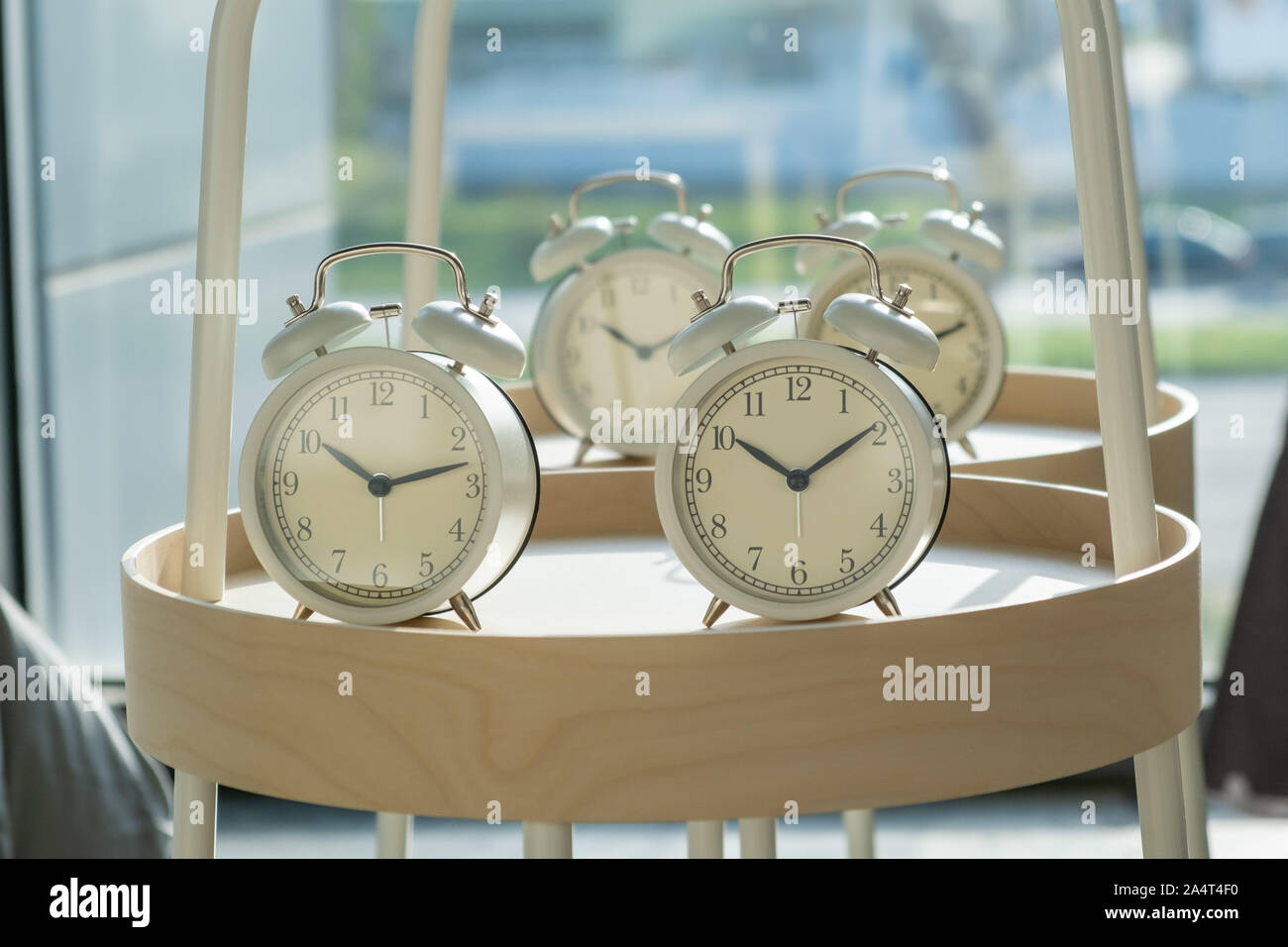 Retro styled alarm clocks on round shelf with shallow focus Stock Photo