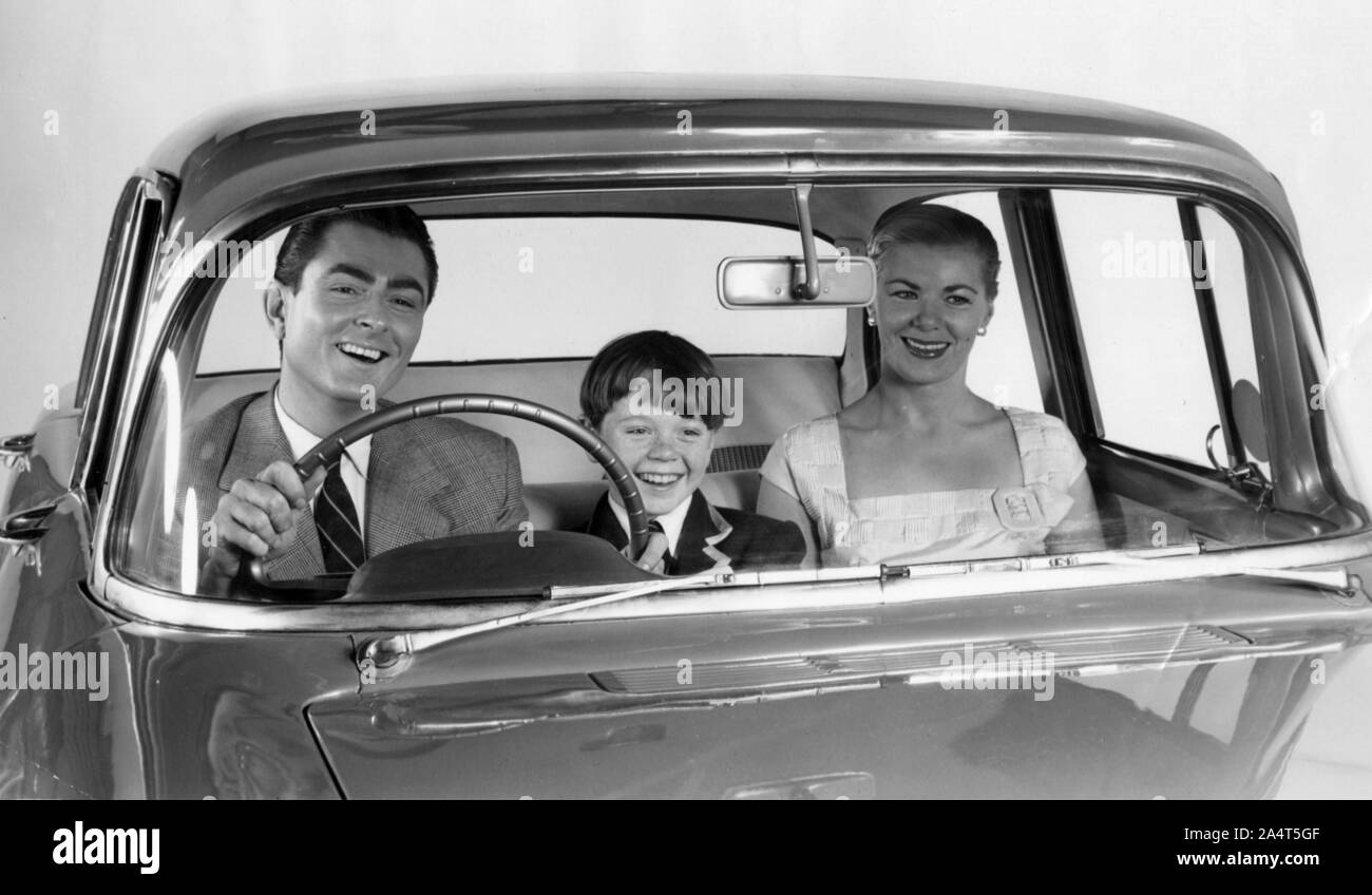 1957 Vauxhall Victor with family together in front seat. Stock Photo