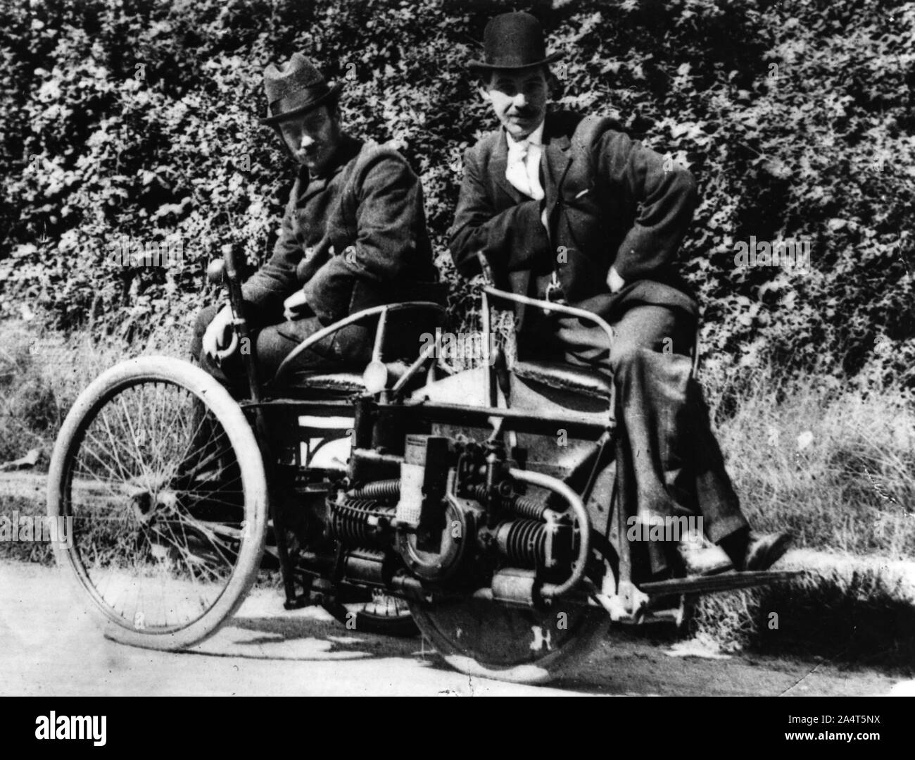 Herbert Austin (left) on 1897 Wolseley Tricar. Stock Photo