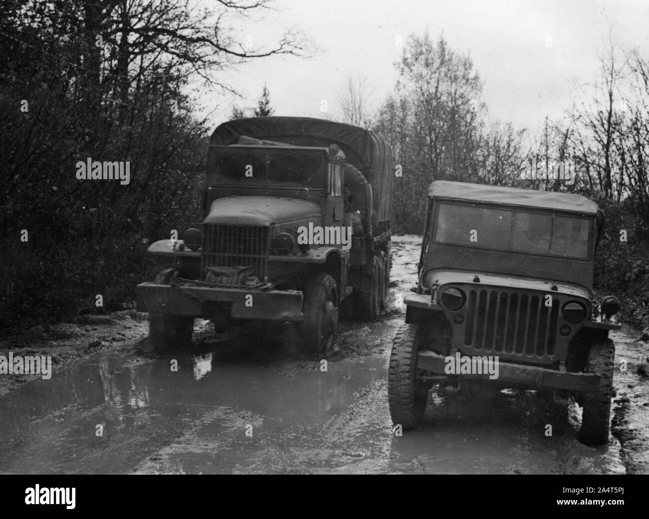 GMC 352 CCKW and Willys Jeep circa 1944. Stock Photo