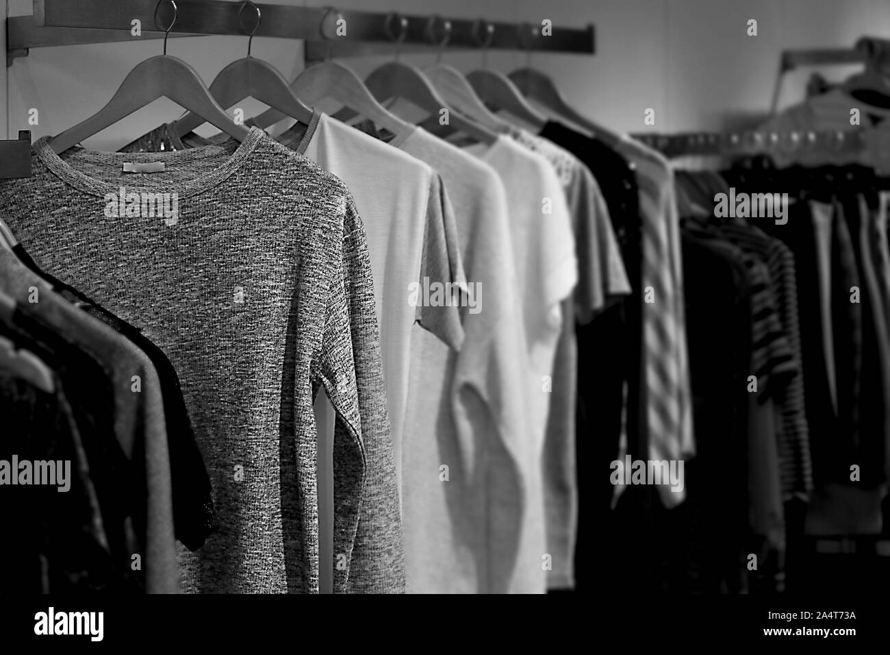Black and white photo of the show room with regals full of trendy boy clothes Stock Photo