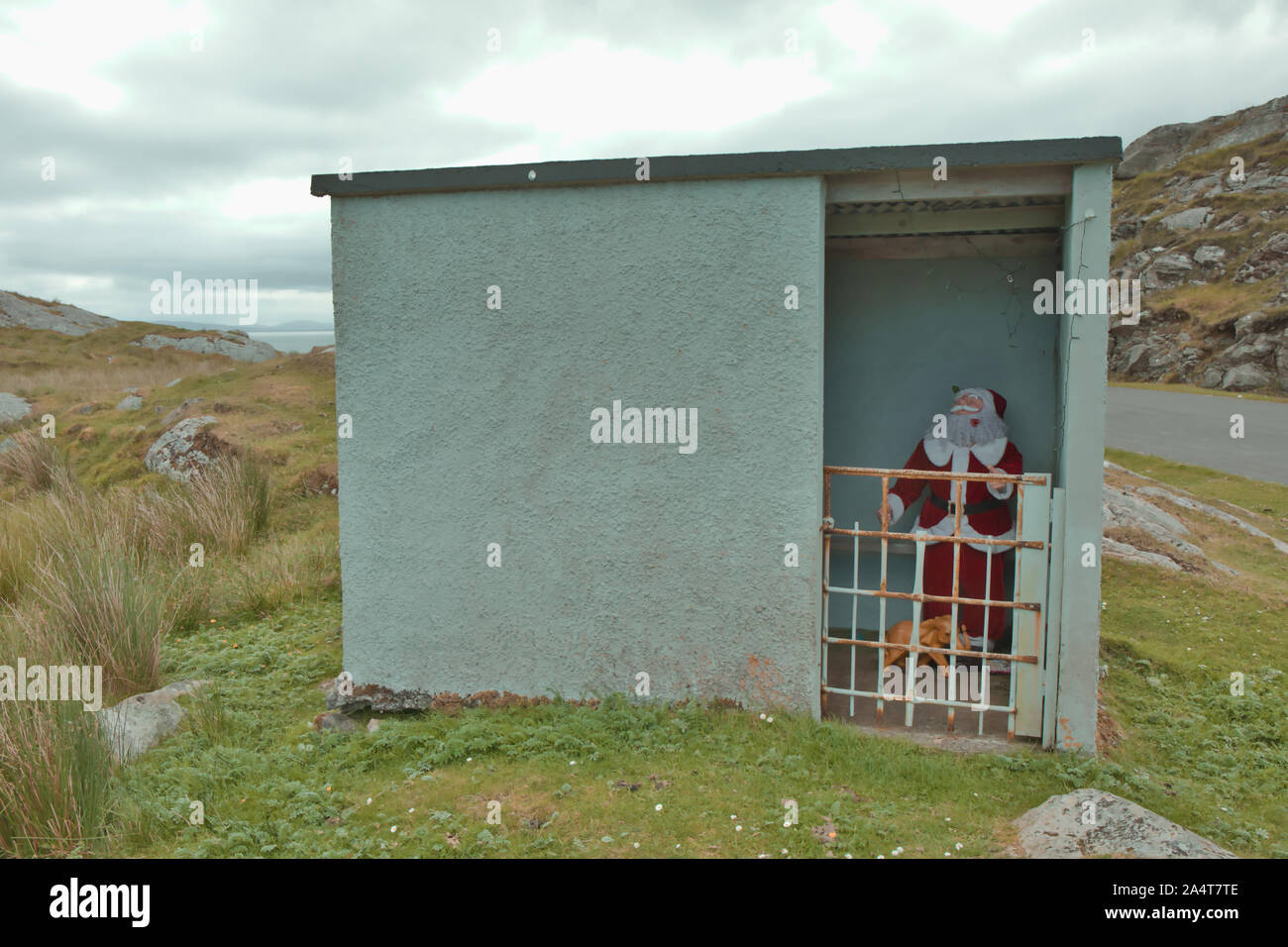 Father Christmas in concrete bus shelter at Manish on the east coast of the Isle of Harris, Outer Hebrides, Scotland Stock Photo