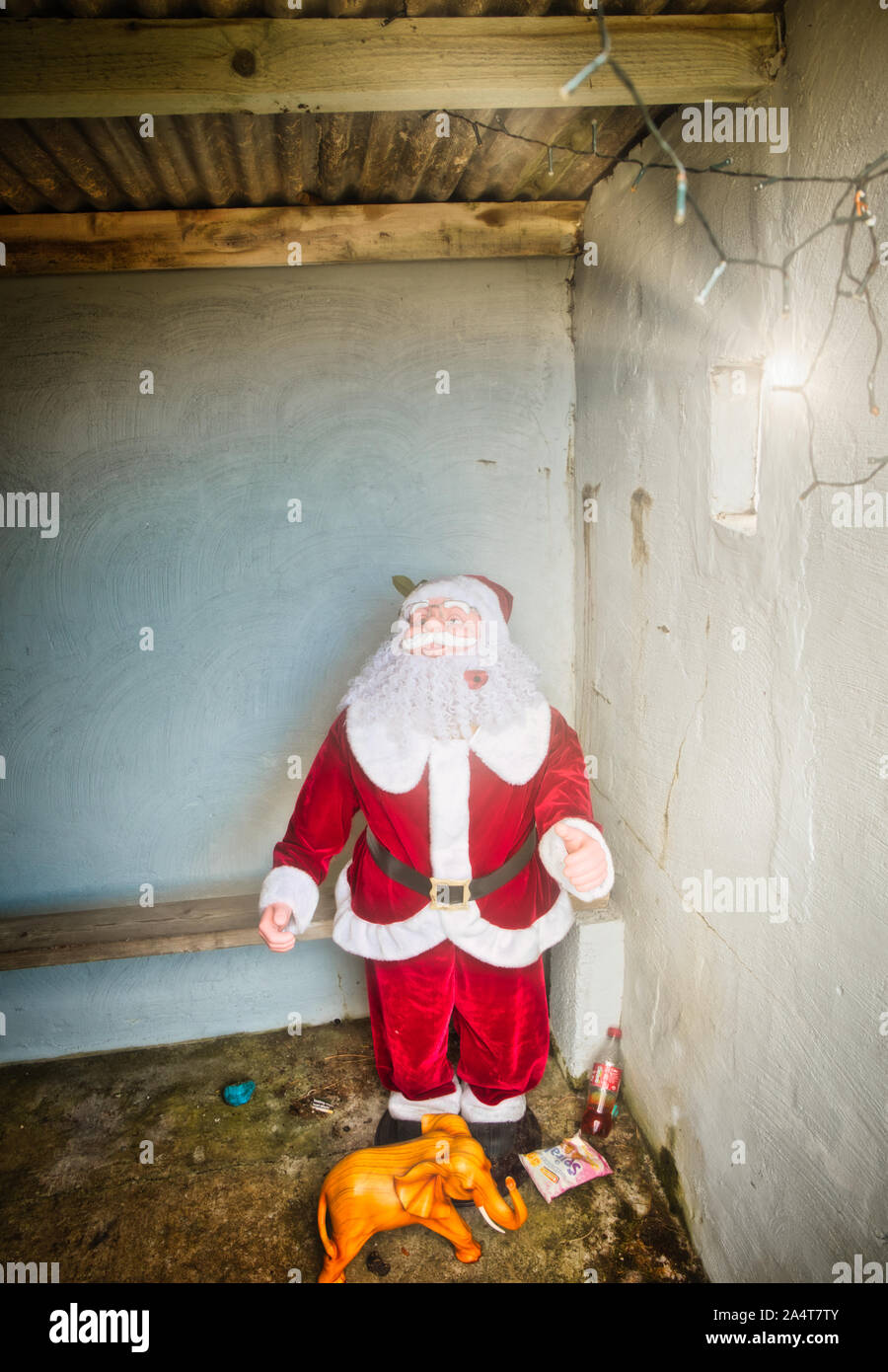 Father Christmas in concrete bus shelter at Manish on the east coast of the Isle of Harris, Outer Hebrides, Scotland Stock Photo