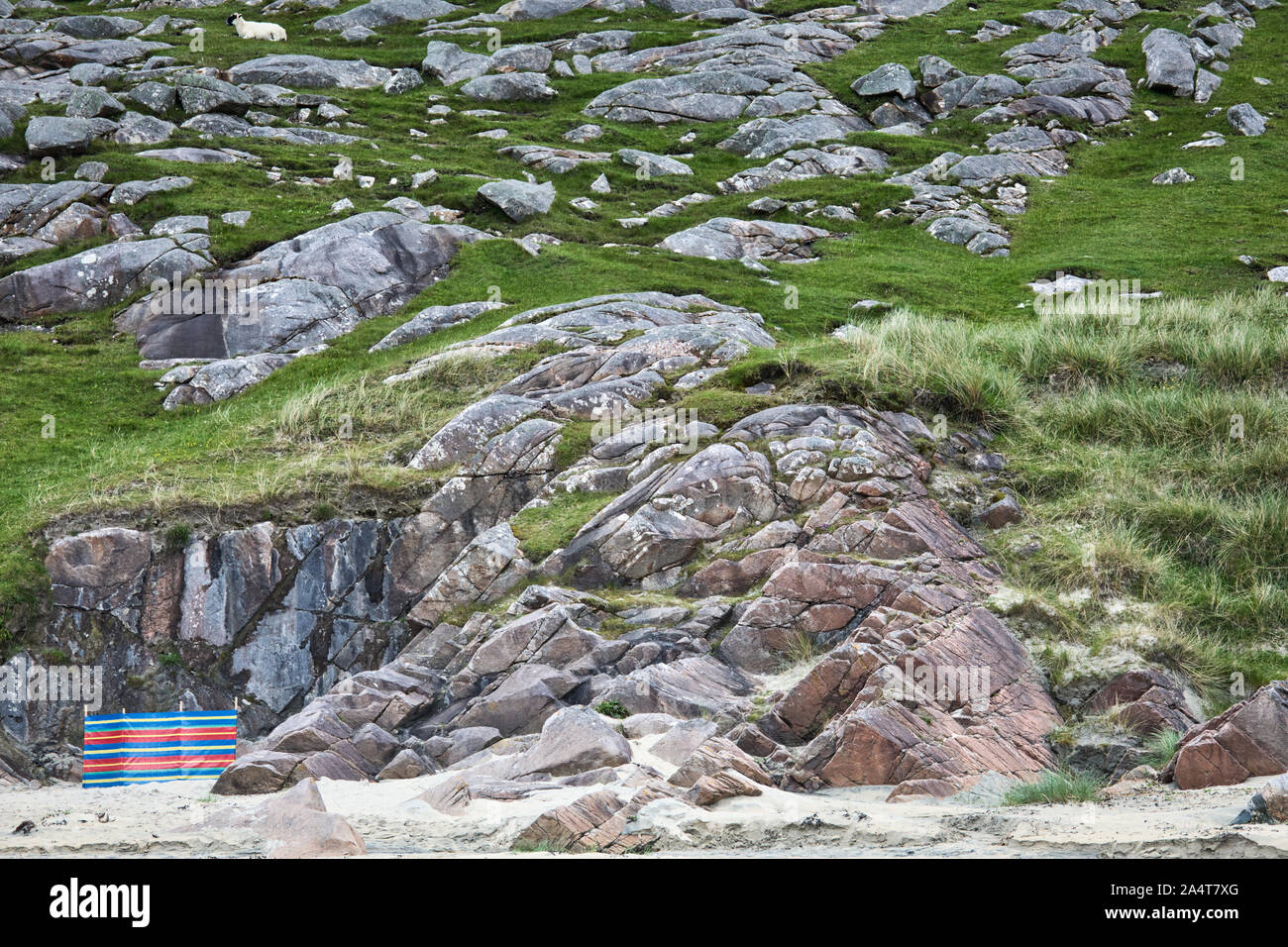 Striped windbreak beneath cliffs on beach, Isle of Harris, Outer Hebrides, Scotland Stock Photo