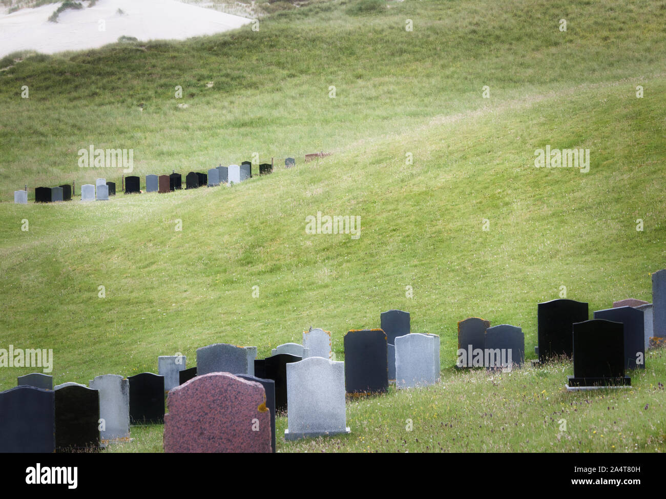 Blank gravestones headstones in graveyard behind sand dunes at Hushinish, Isle of Harris, Outer Hebrides, Scotland Stock Photo