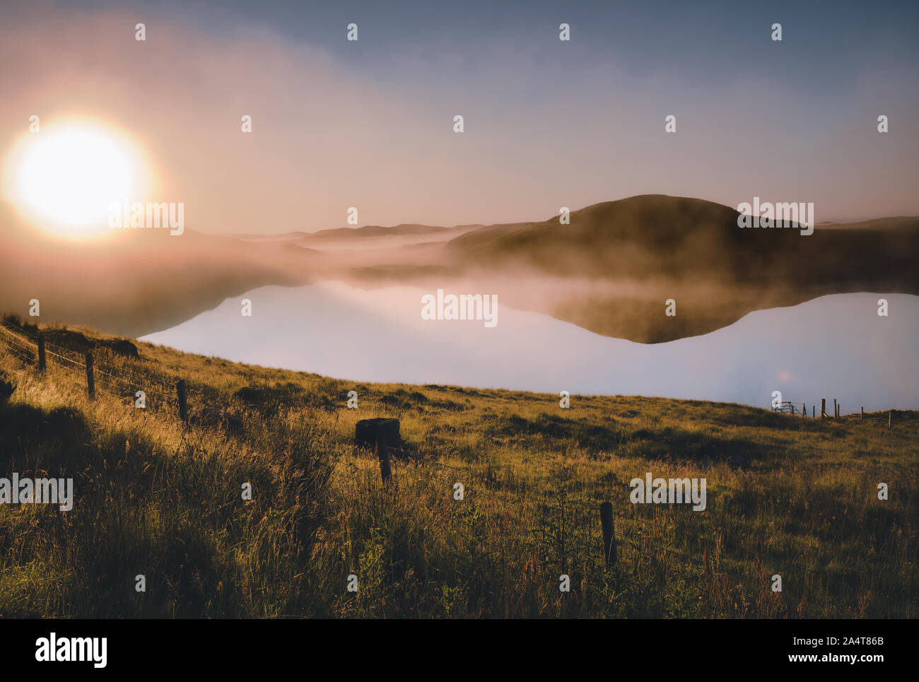 Misty summer sunrise over loch, Isle of Lewis, Outer Hebrides, Scotland Stock Photo