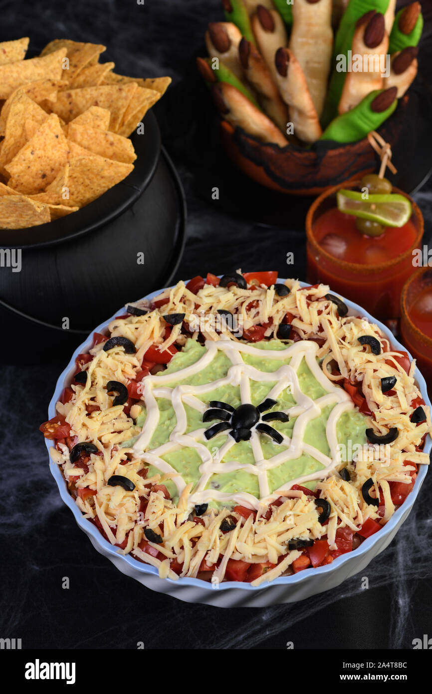 Spooky Halloween Seven Layer Taco Dip Turn a classic appetizer into a