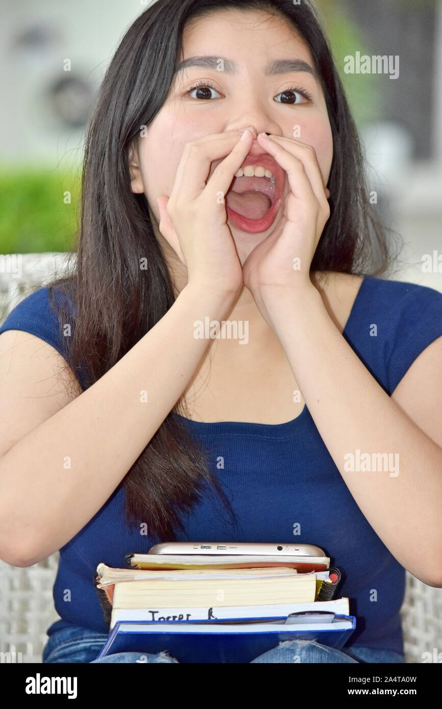 Chinese Student Teenager School Girl Yelling With Notebooks Stock Photo