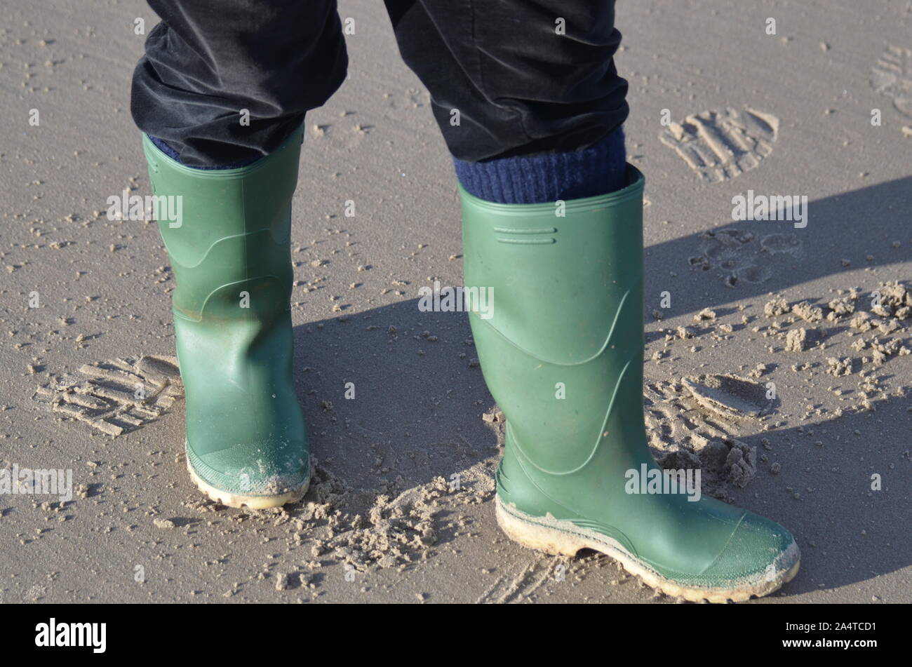 Green wellington boots on the beach Stock Photo - Alamy