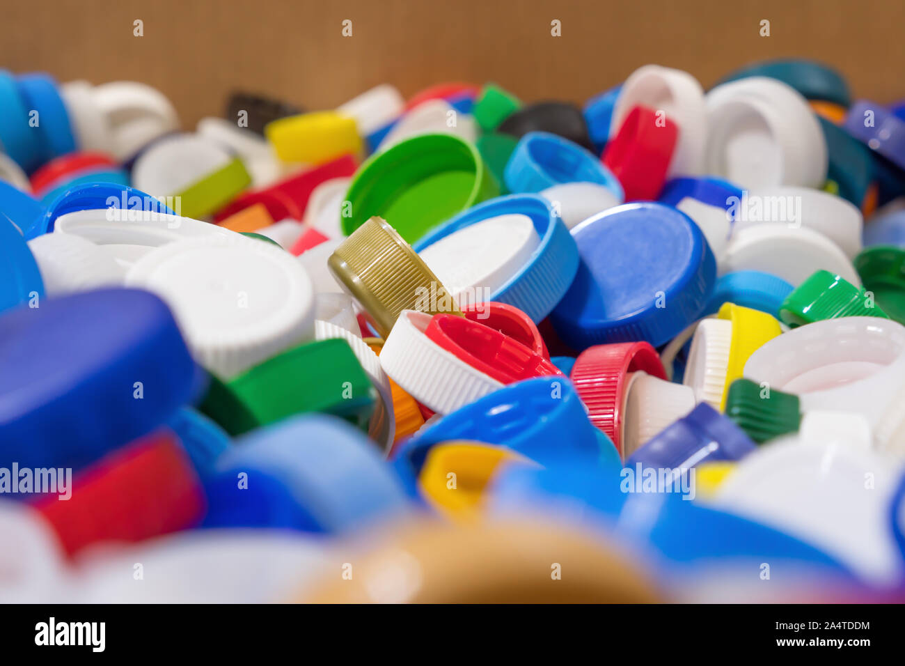 Background of lots of plastic caps. Group of objects for your design. Waste recycling. Recycling concept. Damage for nature. Group of beverage lid for your design. Clipping paths object Stock Photo