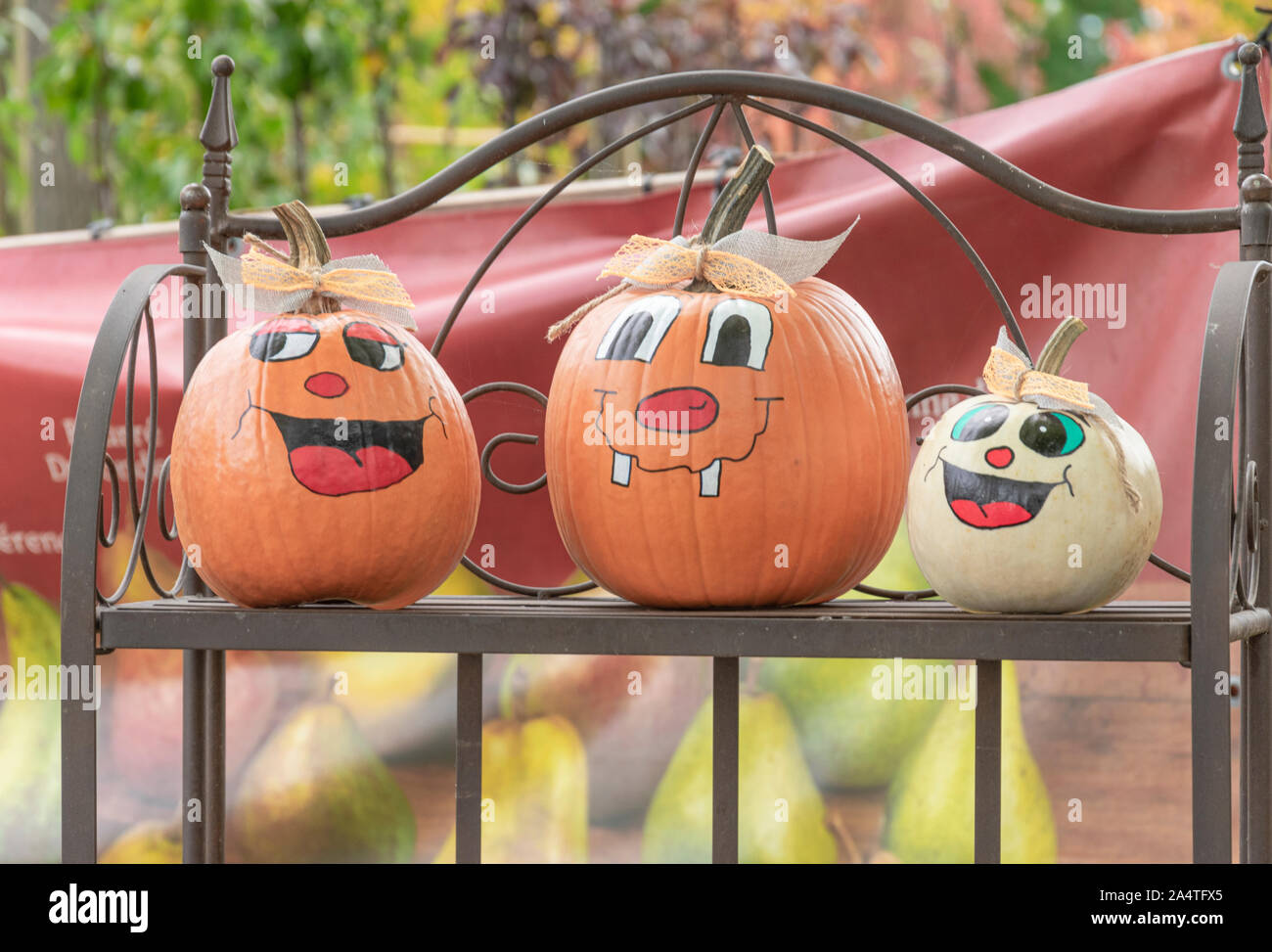 Pumpkins with happy faces painted up ther body Stock Photo