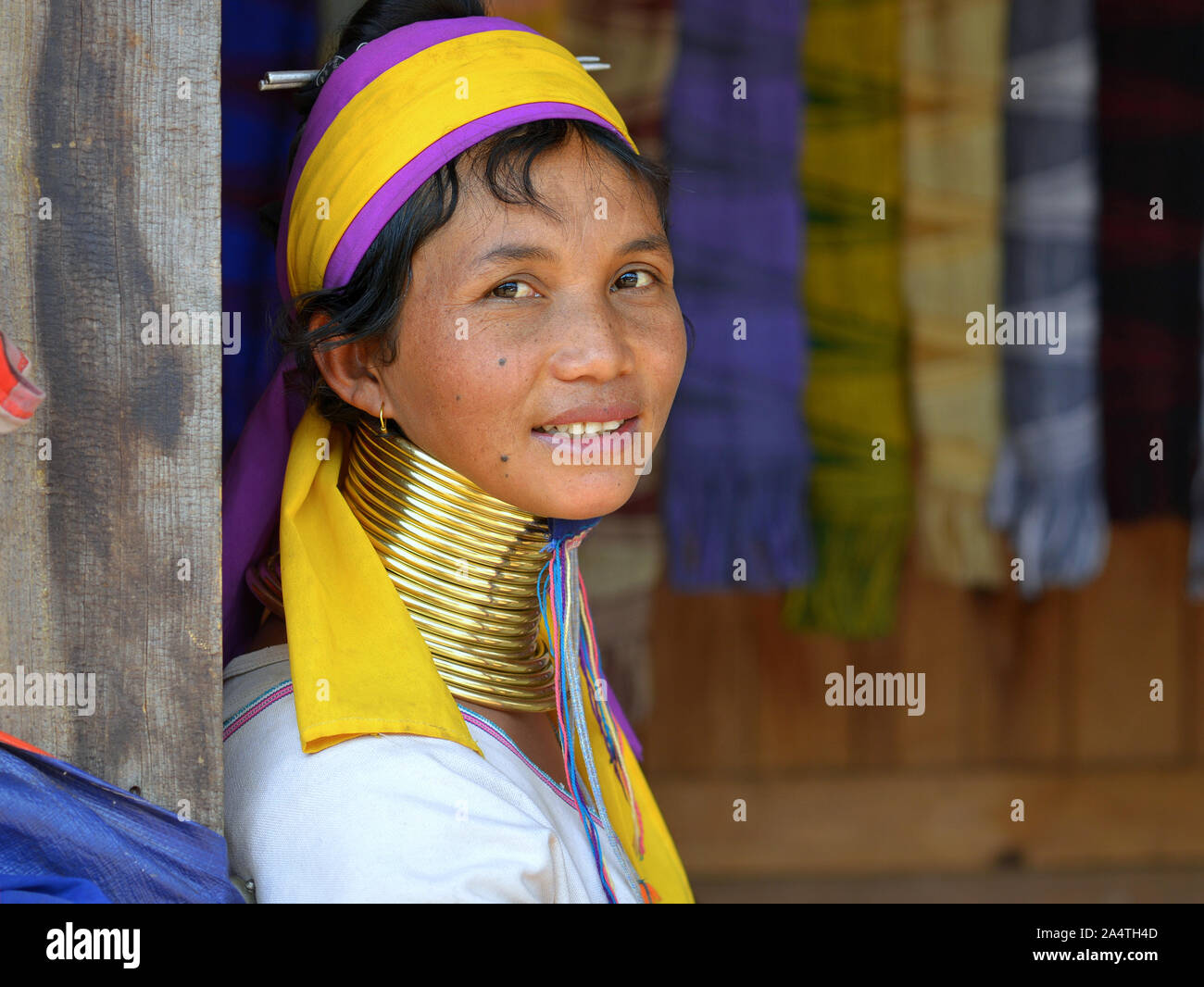 Myanmarese Kayan Lahwi woman ('giraffe woman”) with tribal brass neck rings/coils smiles for the camera. Stock Photo