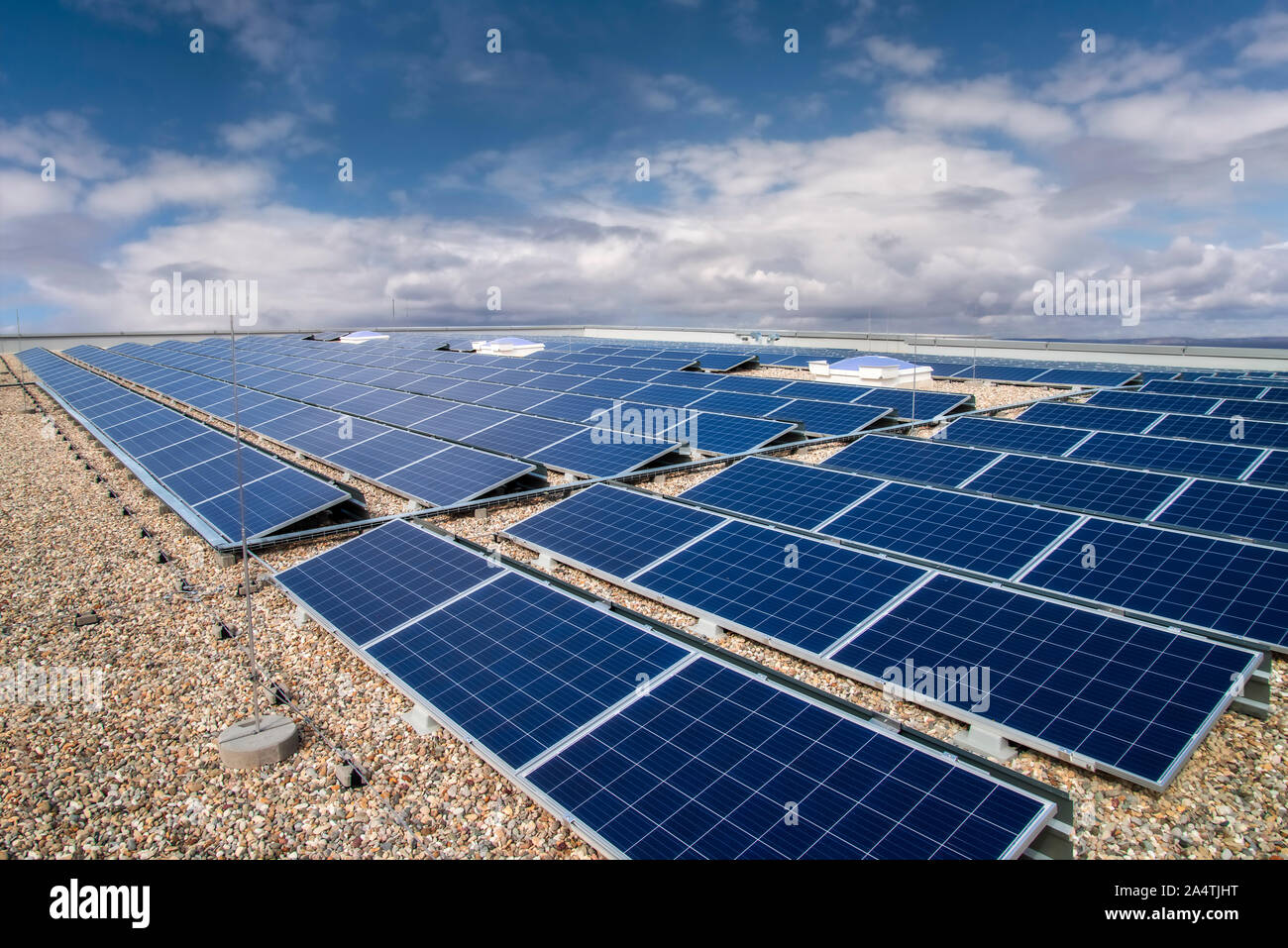 On the roof of a commercial property installed photovoltaic system Stock Photo