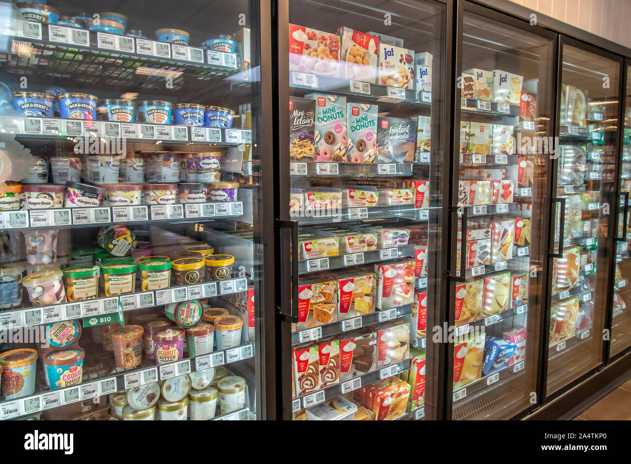 Modern refrigerated shelves with frozen goods in a supermarket Stock Photo