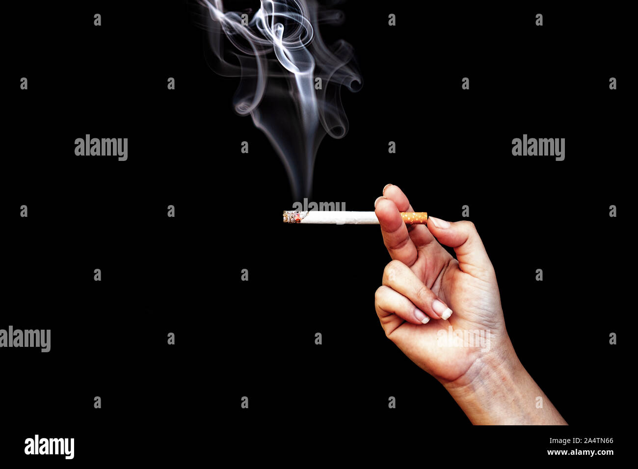 Image of cigarette in hand with smoke Stock Photo - Alamy