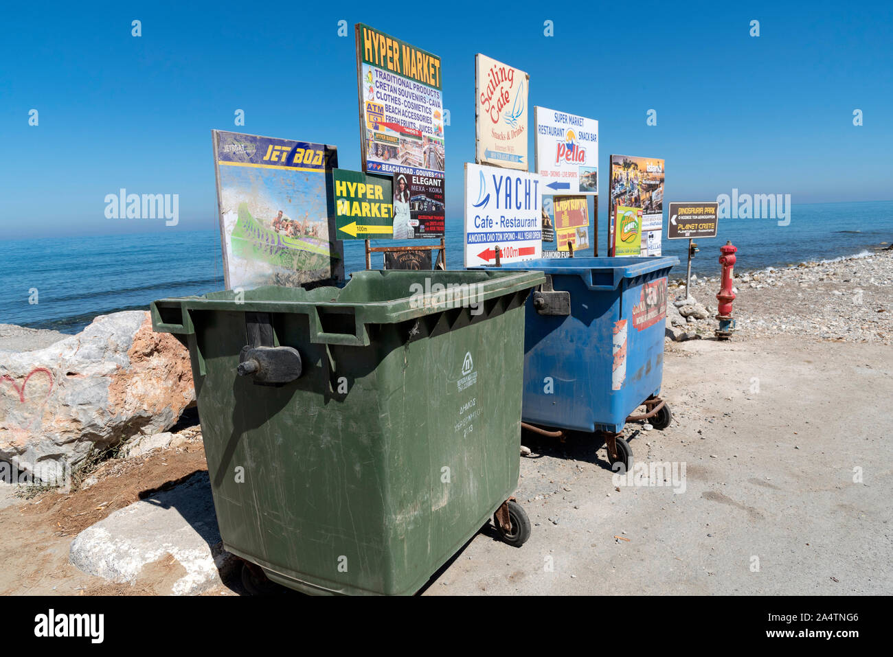 Gouves, Crete, Greece, October 2019.  Rubbish and recycling bins on the beach road in the seaside resort of Gouves, Crete. Stock Photo