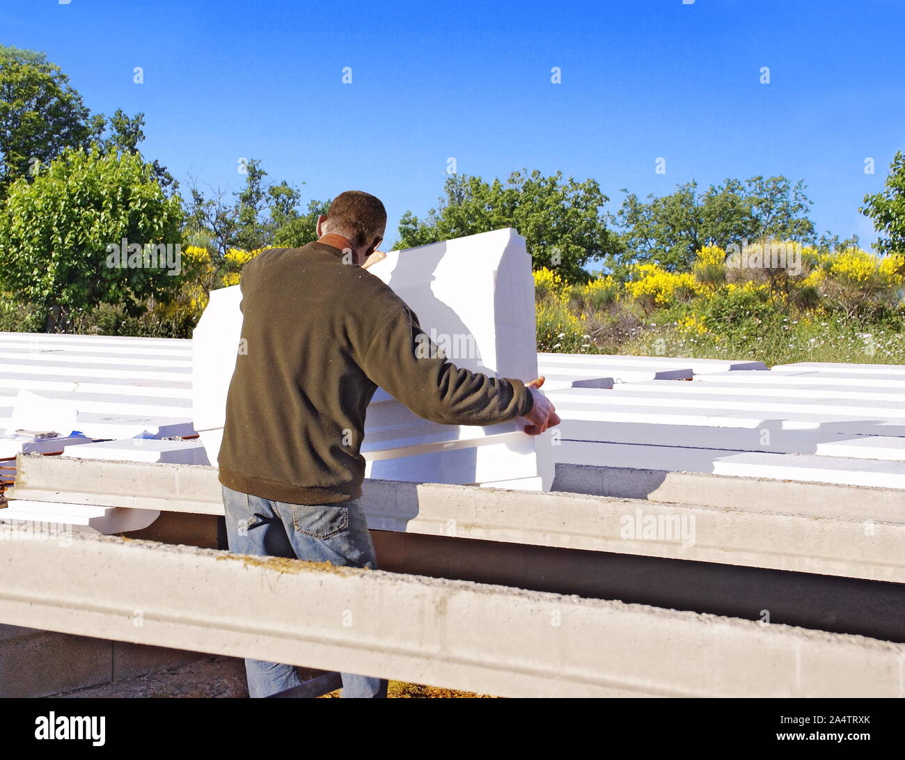 Distribution of concrete for the realization of the floor of a house under construction. Stock Photo