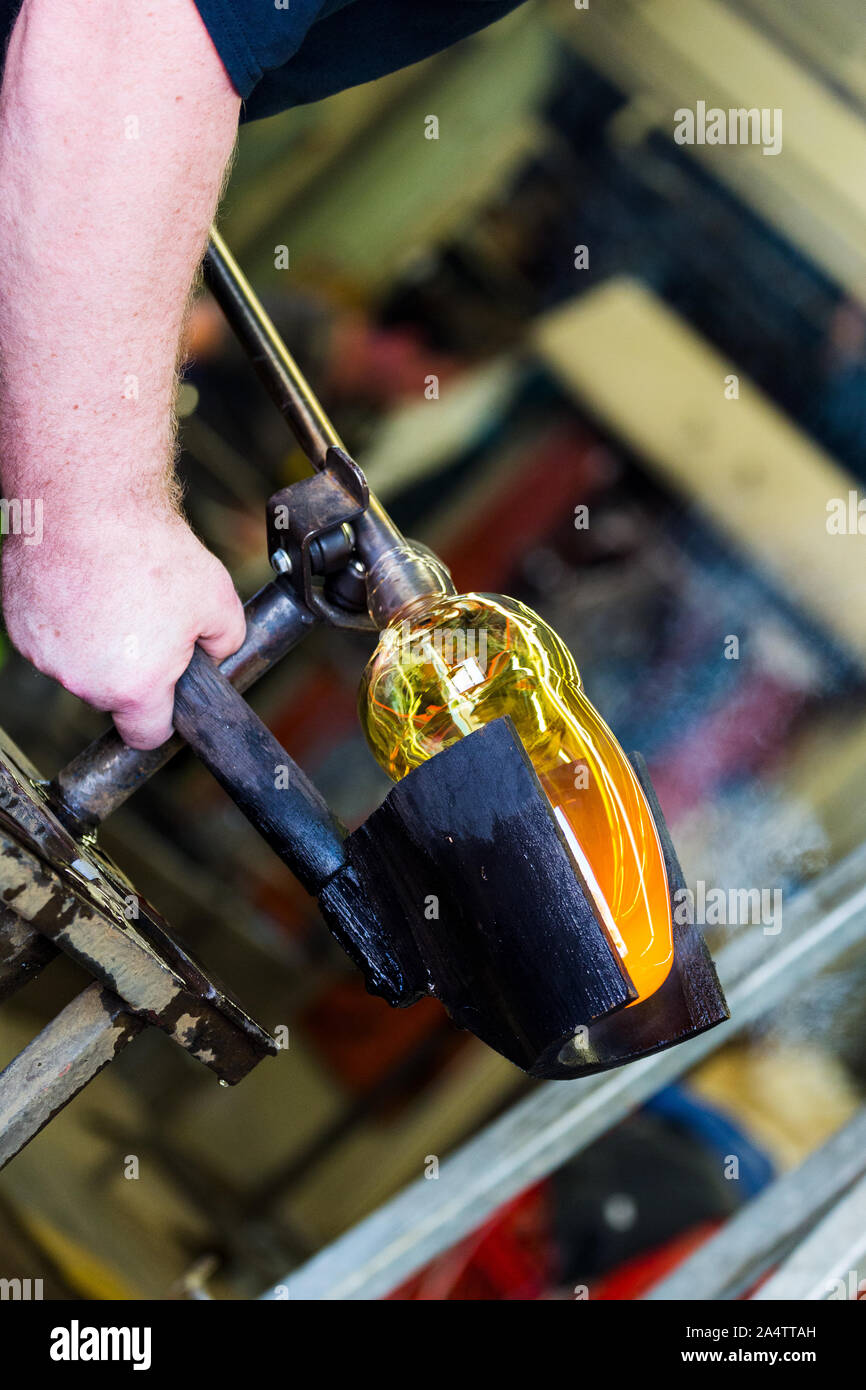 Glass worker spinning and shaping  Molten glass  Canada, Halifax. Nova scotia. Harbour  Waterfront. Stock Photo