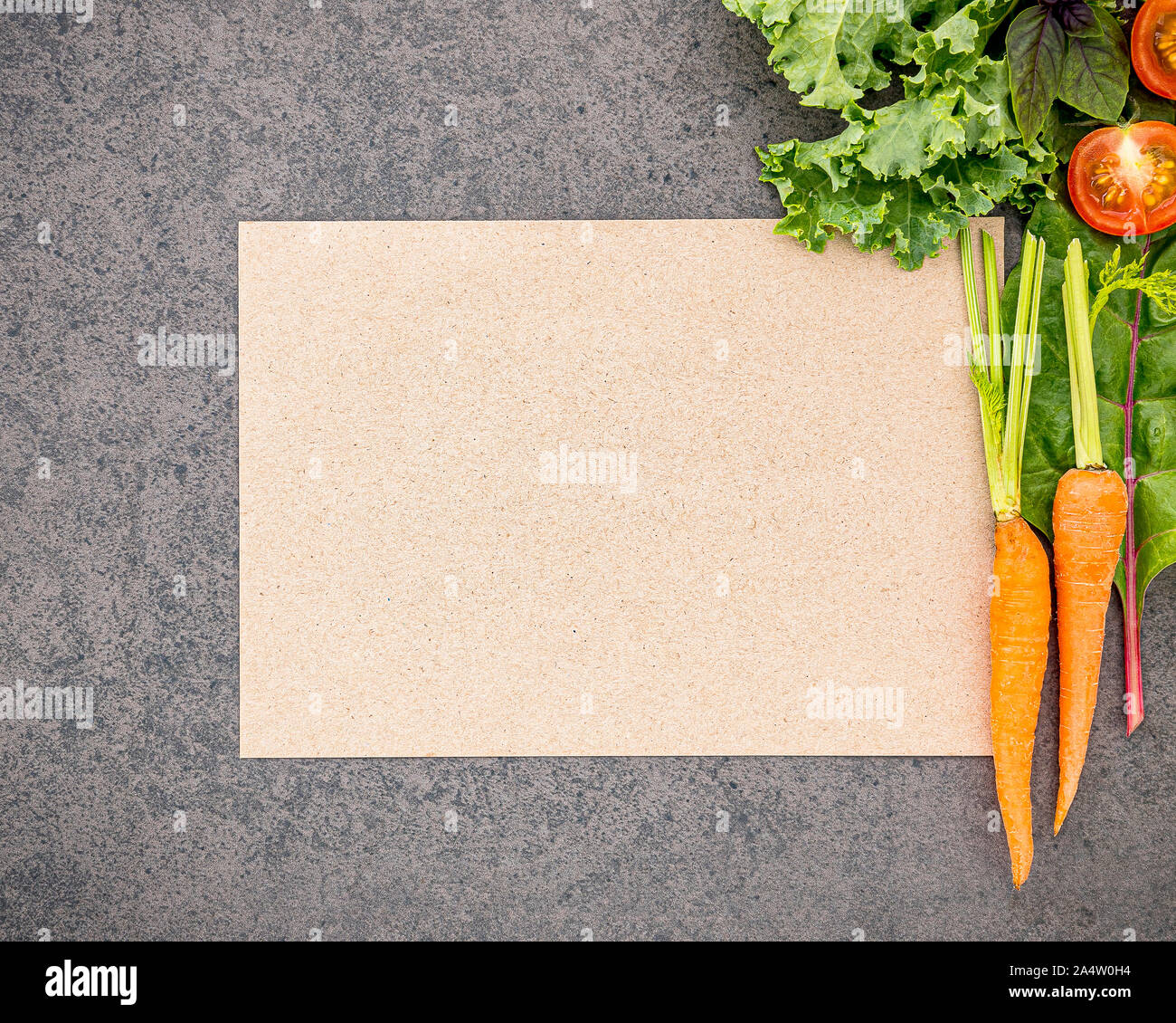 Wooden spoon and vegetables on dark stone background. Healthy food and ...