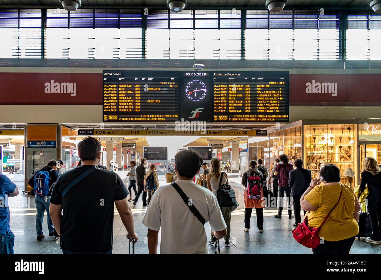 Passengers looking at the train departure board at Porta Nuova railway  station ,Turin,Italy Stock Photo - Alamy