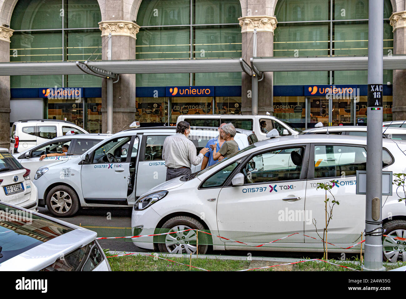 Turin taxi drivers talking whist waiting for a fare at the taxi rank  outside Porta Nuova railway station ,Turin,Italy Stock Photo - Alamy