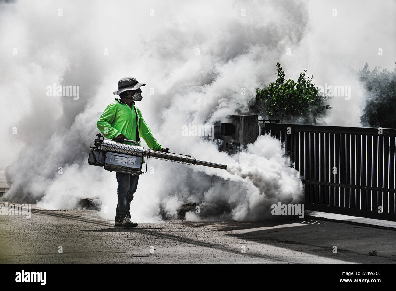 Man using fogger machine to control dangerous from mosquitoes