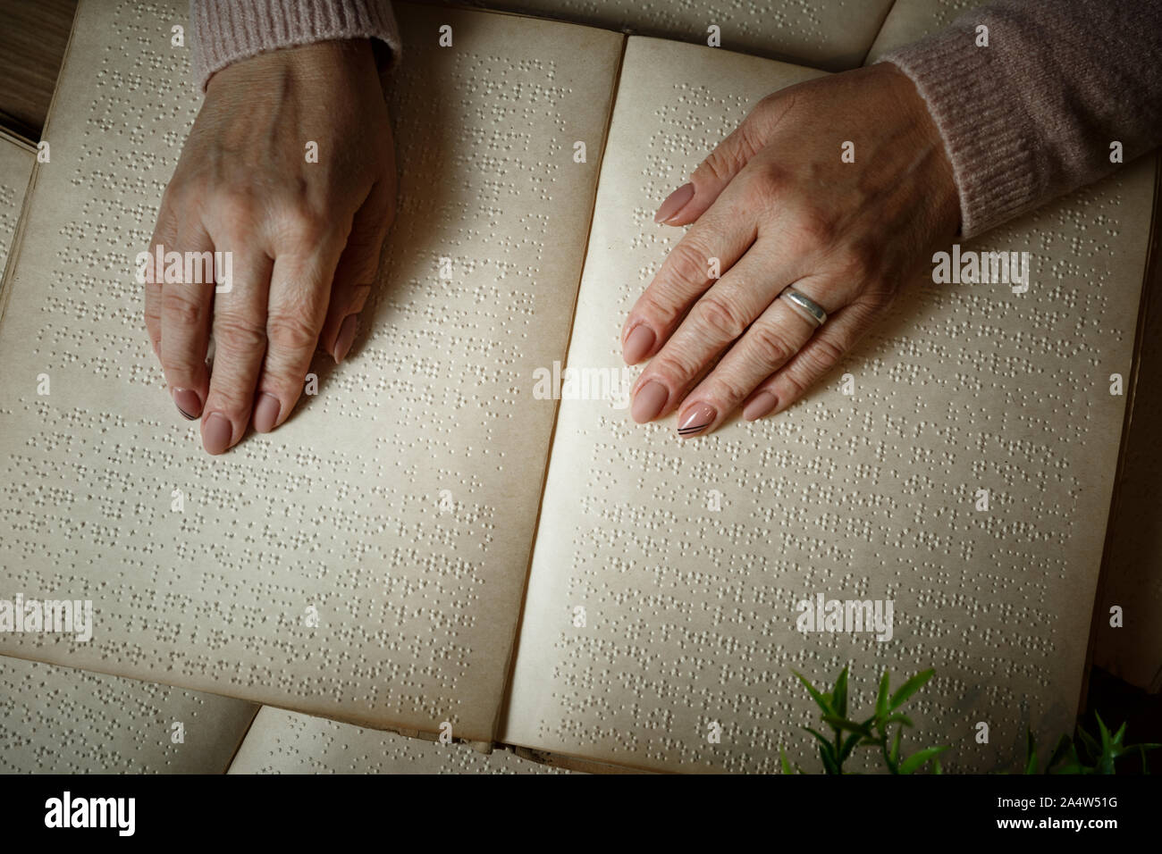 woman reading braille text on old book Stock Photo Alamy