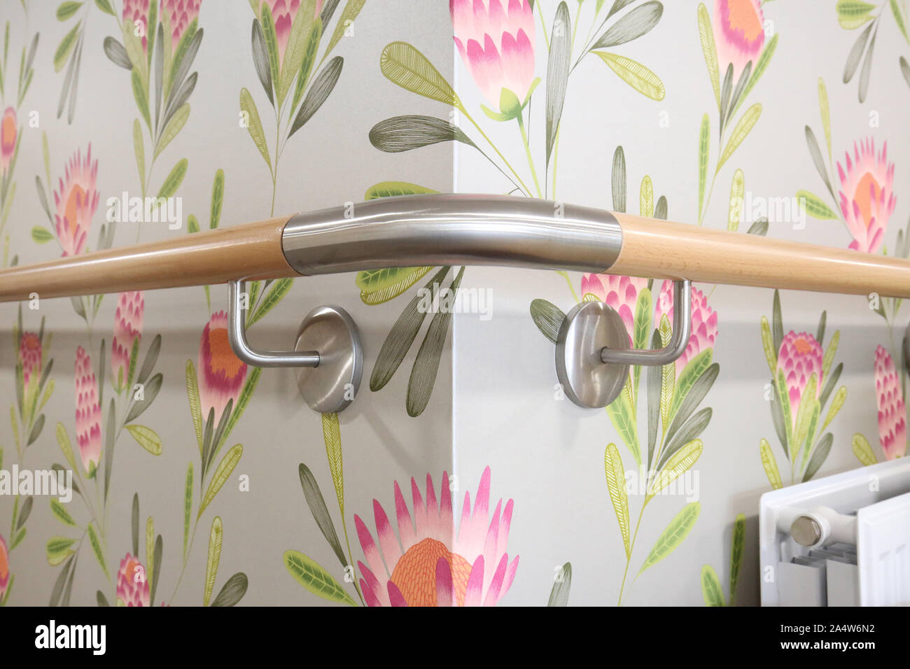 Closeup of timber and brushed steel, wall mouted safety rails in a newly refurbished care home for elderly people near Wakefield, UK Stock Photo