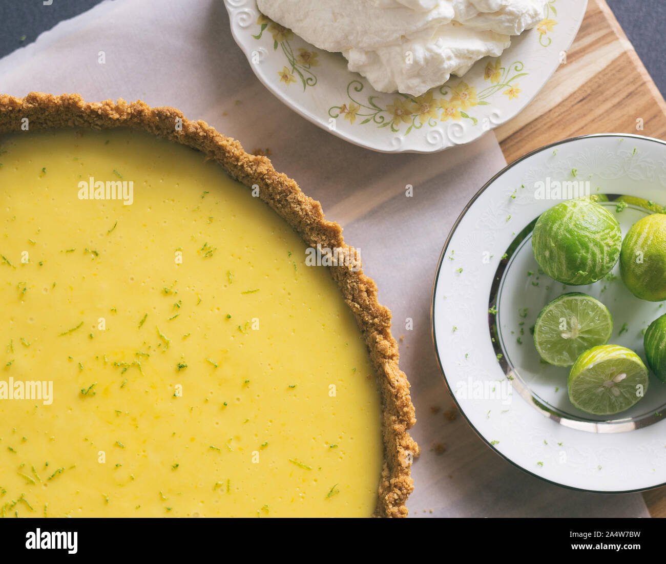 Homemade Key lime pie shown on parchment paper, shown with extra key