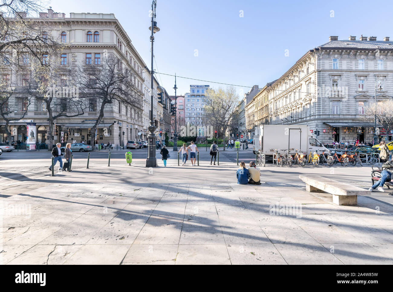 Budapest, Hungary - September 28, 2019: Jokai Square or Jókai tér on Andrássy út with Jókai Mór and Ady Endre sculptures and people walking on street. Stock Photo