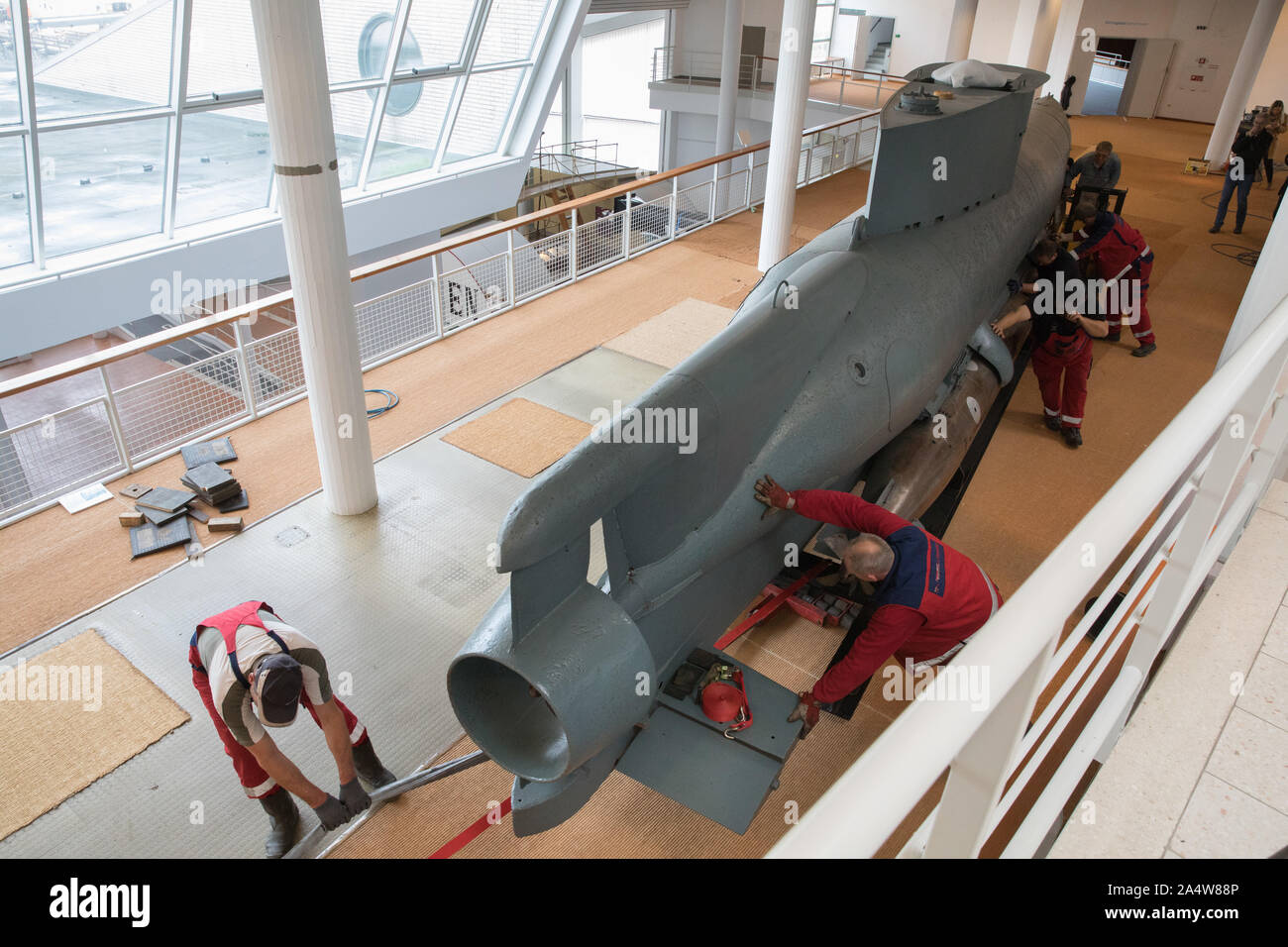 Bremerhaven, Germany. 16th Oct, 2019. Workers push a miniature ...