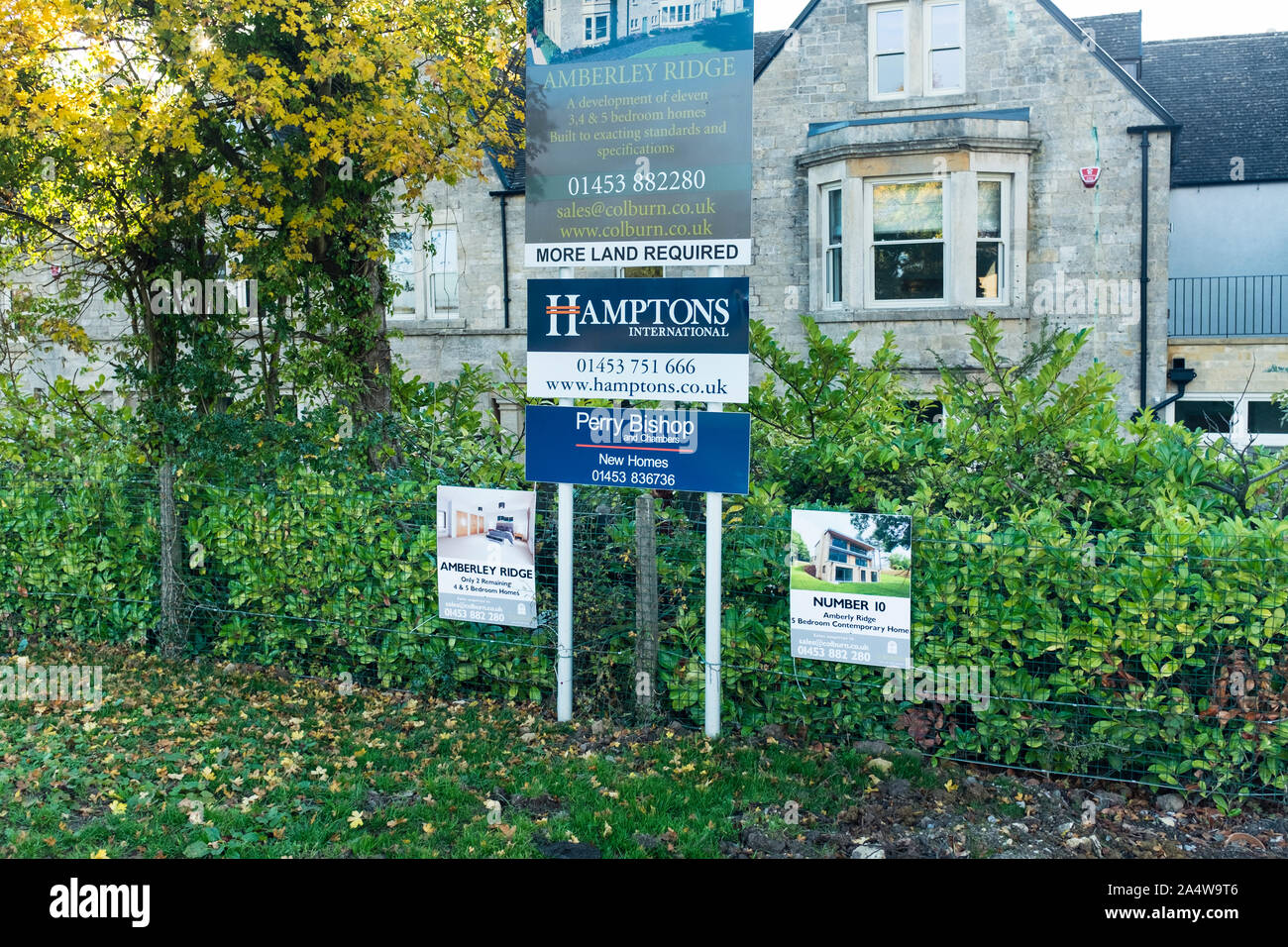 Estate Agent's sign outside of houses, Gloucestershire, UK Stock Photo