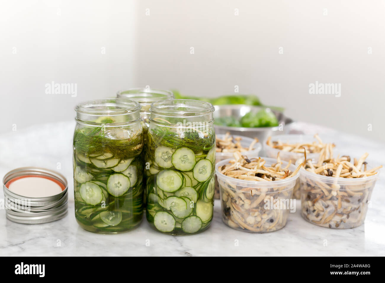 Homemade slice cucumbers pickle in a Jar on marble table Stock Photo