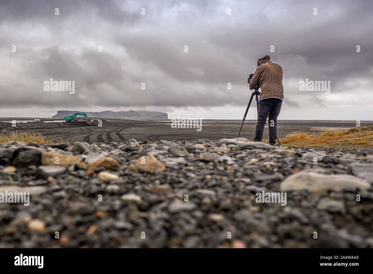 Filmmaker taking videos, Hjorleifshofdi, South Coast, Iceland Stock Photo
