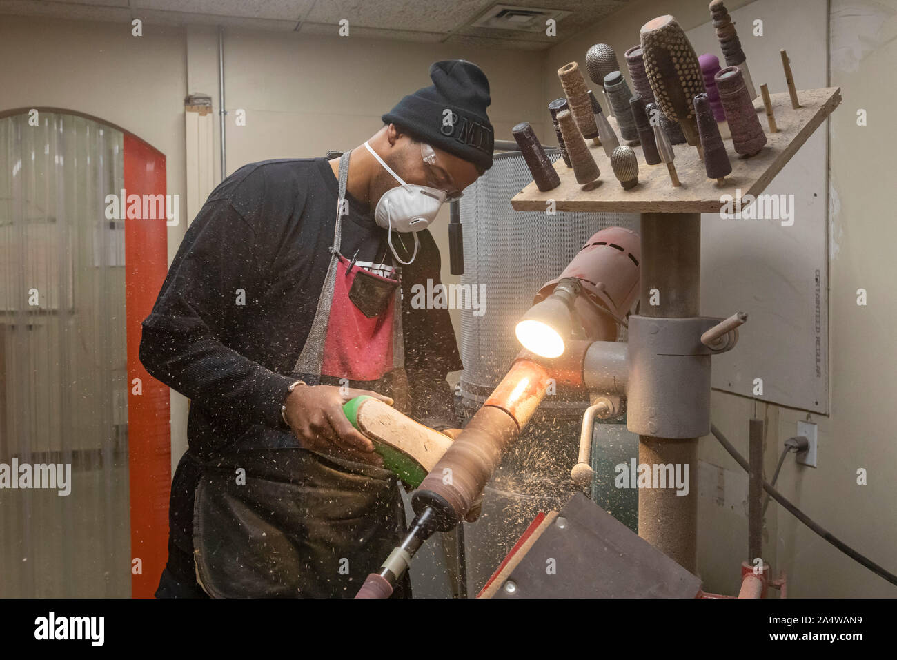 Detroit, Michigan - Nathaniel Crawford II, an Air Force veteran, sands insoles for footwear at PingreeDetroit. Pingree is a worker-owned company that Stock Photo