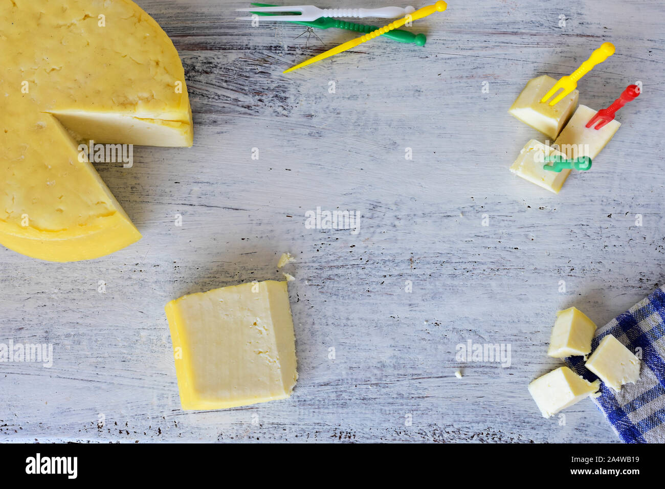 Little cheese cubes whit cocktail sticks over white wooden background
