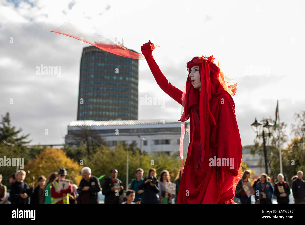 Cardiff, Wales, UK, October 16th 2019. The Red Rebels of global environmental movement Extinction Rebellion outside Cardiff City Hall, where the Low Carbon Wales conference is being held. Police have banned Extinction Rebellion protests from continuing anywhere in London. Credit: Mark Hawkins/Alamy Live News Stock Photo