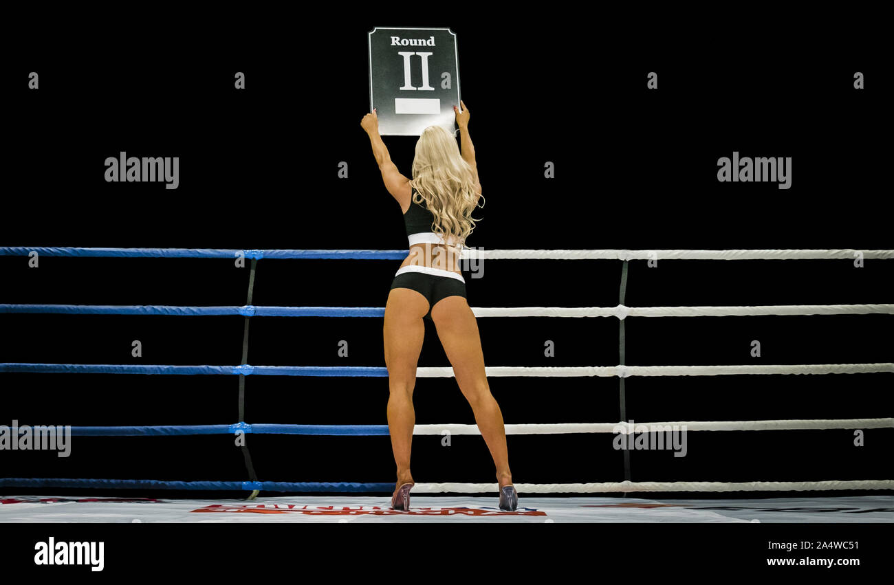 Back Boxing Ring Girl Carrying Sign That Displays Number Of Upcoming