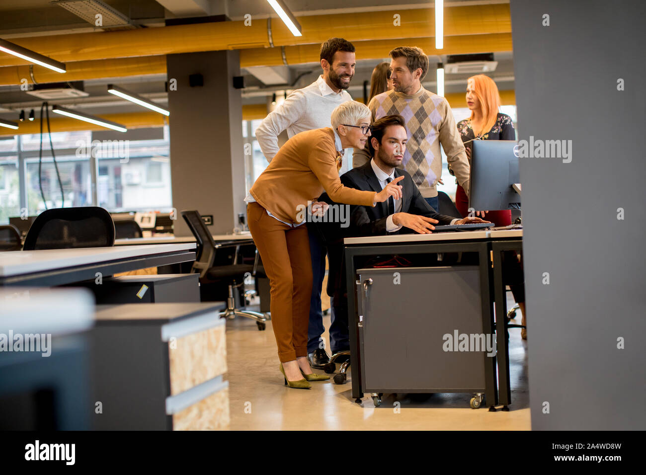 Senior businesswoman and young business people work in a modern office Stock Photo