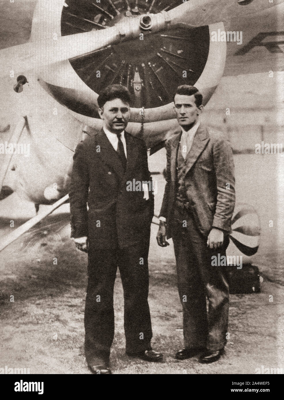 Wiley Post, left and Harold Gatty, seen here in 1931.  Wiley Hardeman Post, 1898 – 1935. American aviator, the first pilot to fly solo around the world.  Harold Charles Gatty, 1903 – 1957.  Australian navigator, aviation pioneer and navigator on Post's circumnavigation flight.  From The Pageant of the Century, published 1934. Stock Photo