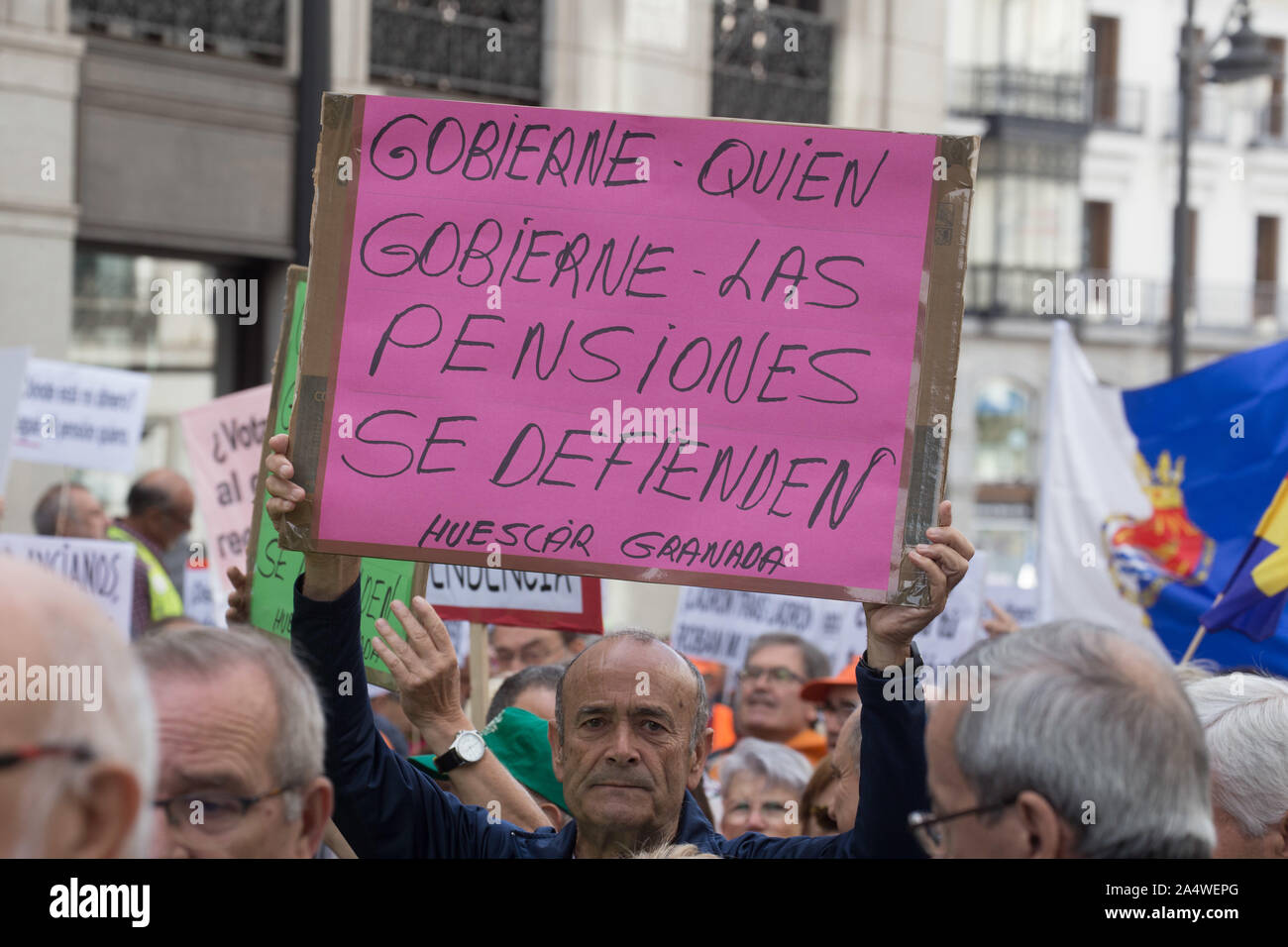 A protester holds a placard that says Govern who governs, we defend the pensions during the demonstration.Retirees walk to Madrid from other regions of Spain to protest worthy pensions and for the government to raise all pensions to € 1080 per month. Stock Photo