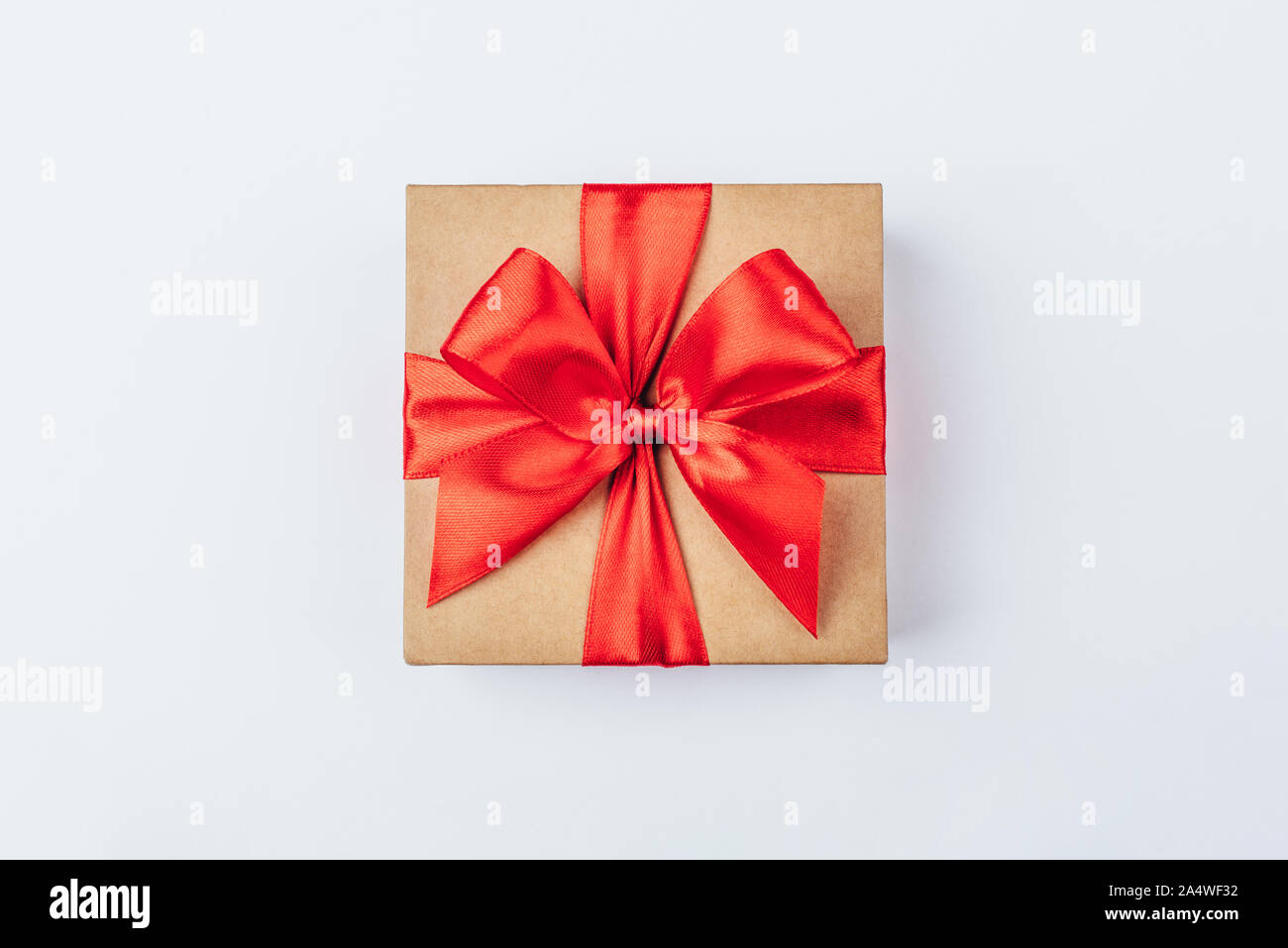 Cardboard gift box with red bow on white background Stock Photo - Alamy