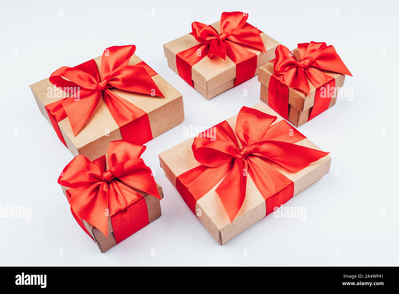 Cardboard gift boxes with red bows on white background Stock Photo - Alamy