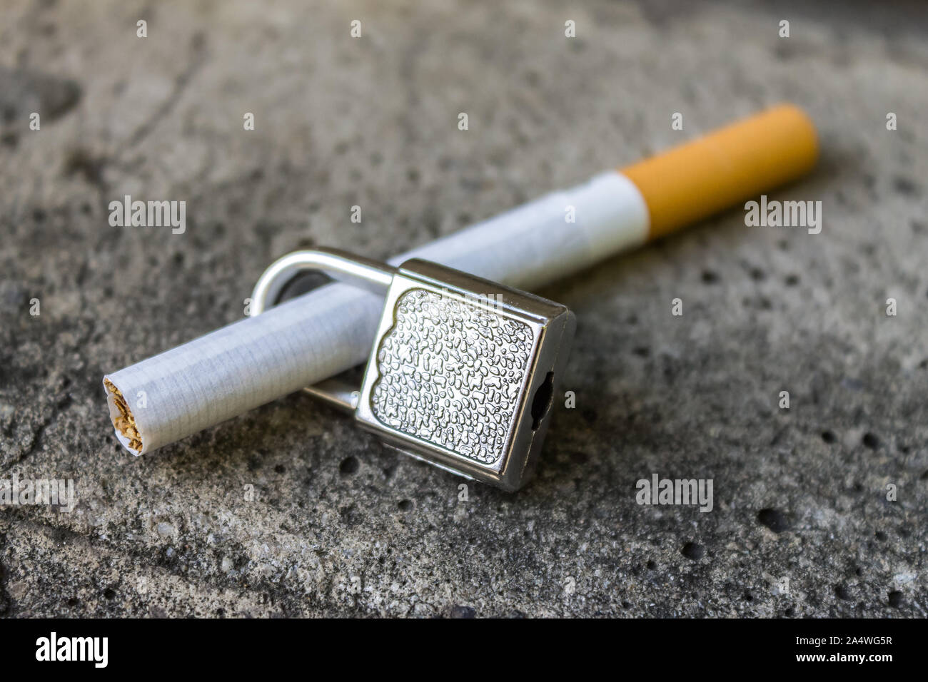 The ban on smoking cigarettes in public places. Cigarette and lock on