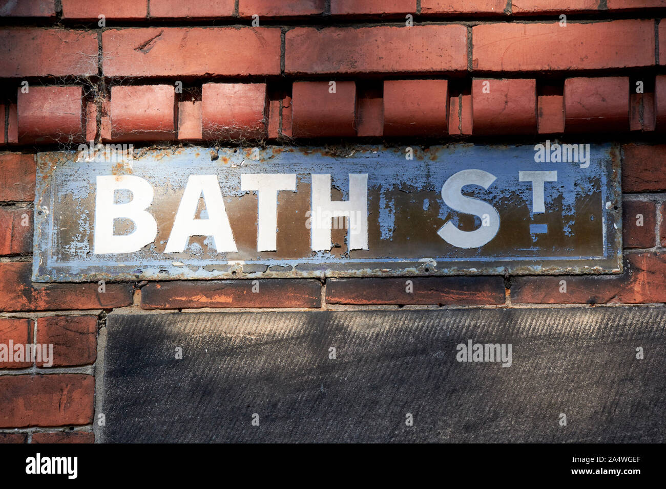 old worn peeling overpainted metal street sign for bath street in Port Sunlight England UK Stock Photo